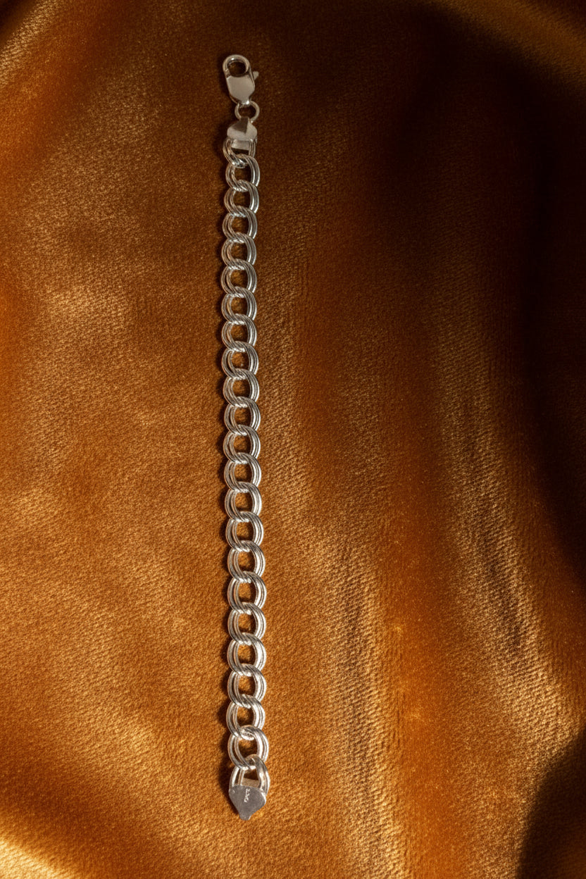 Silver chain bracelet on a Carmel surface