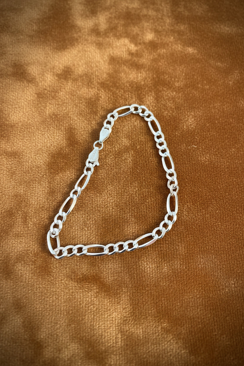 Silver 925 chain on a Carmel textured fabric background