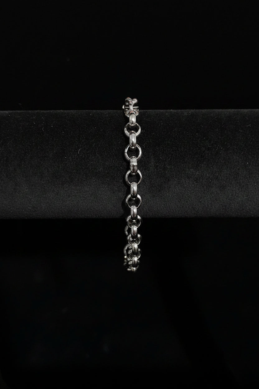 Silver bracelet on a black stand with a Black Velvet background