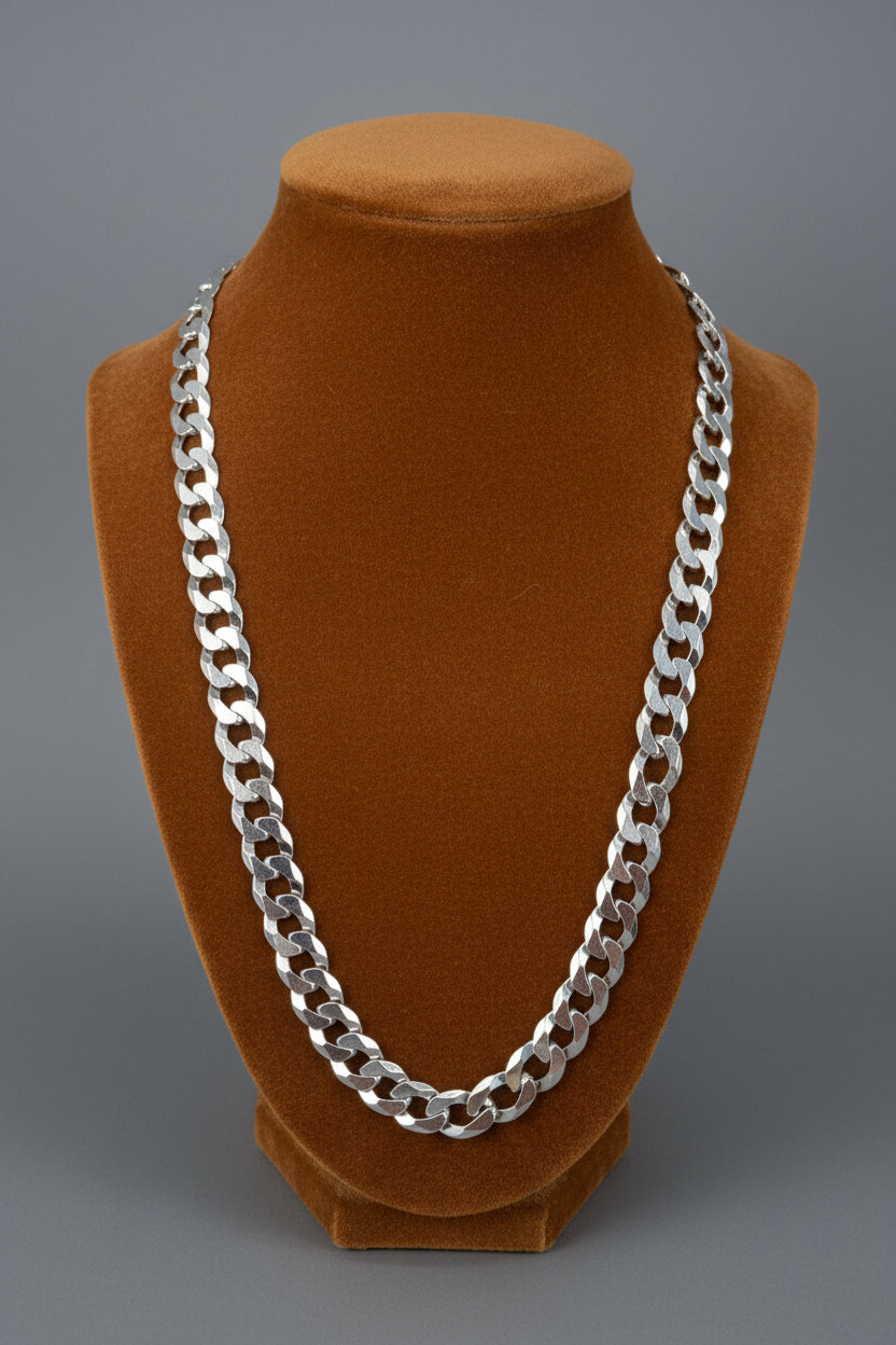 925 Sterling silver Cuban link chain on a Carmel Colored  fabric fixture background