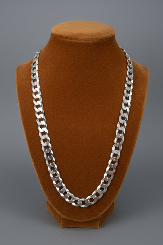 925 Sterling silver Cuban link chain on a Carmel Colored  fabric fixture background