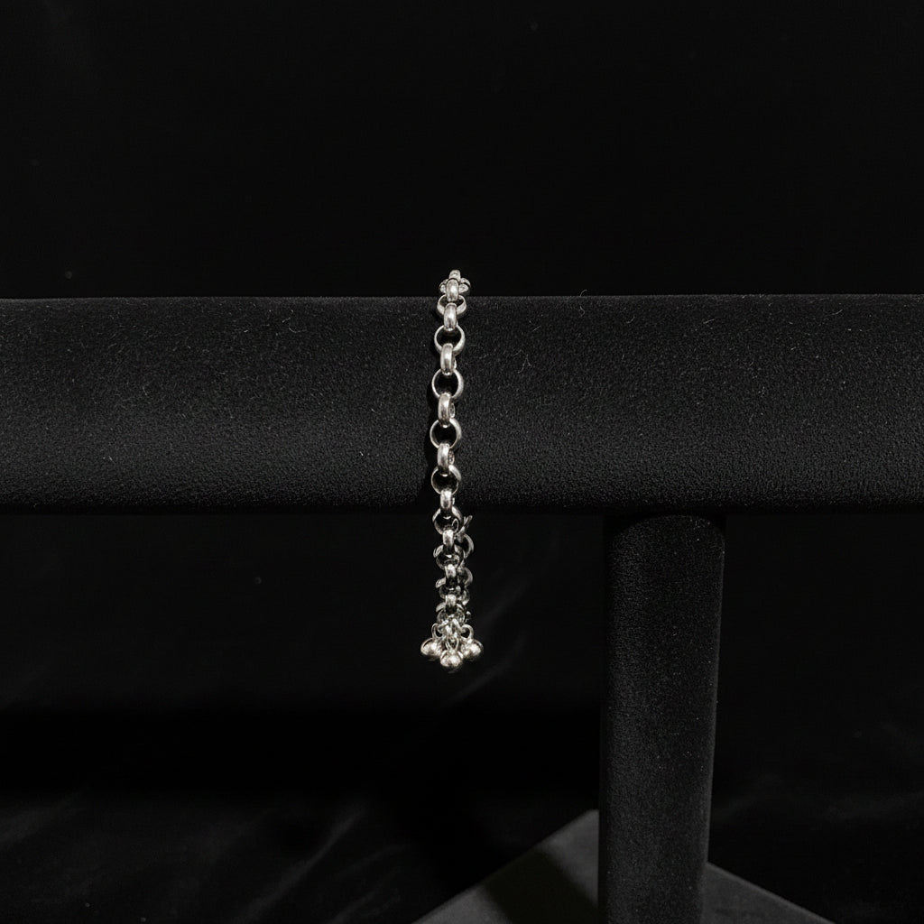 Silver bracelet on a black velvet cushion with a Black Velvet fabric background