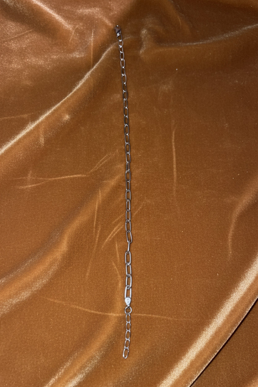 Anklet chain on a textured carmel surface