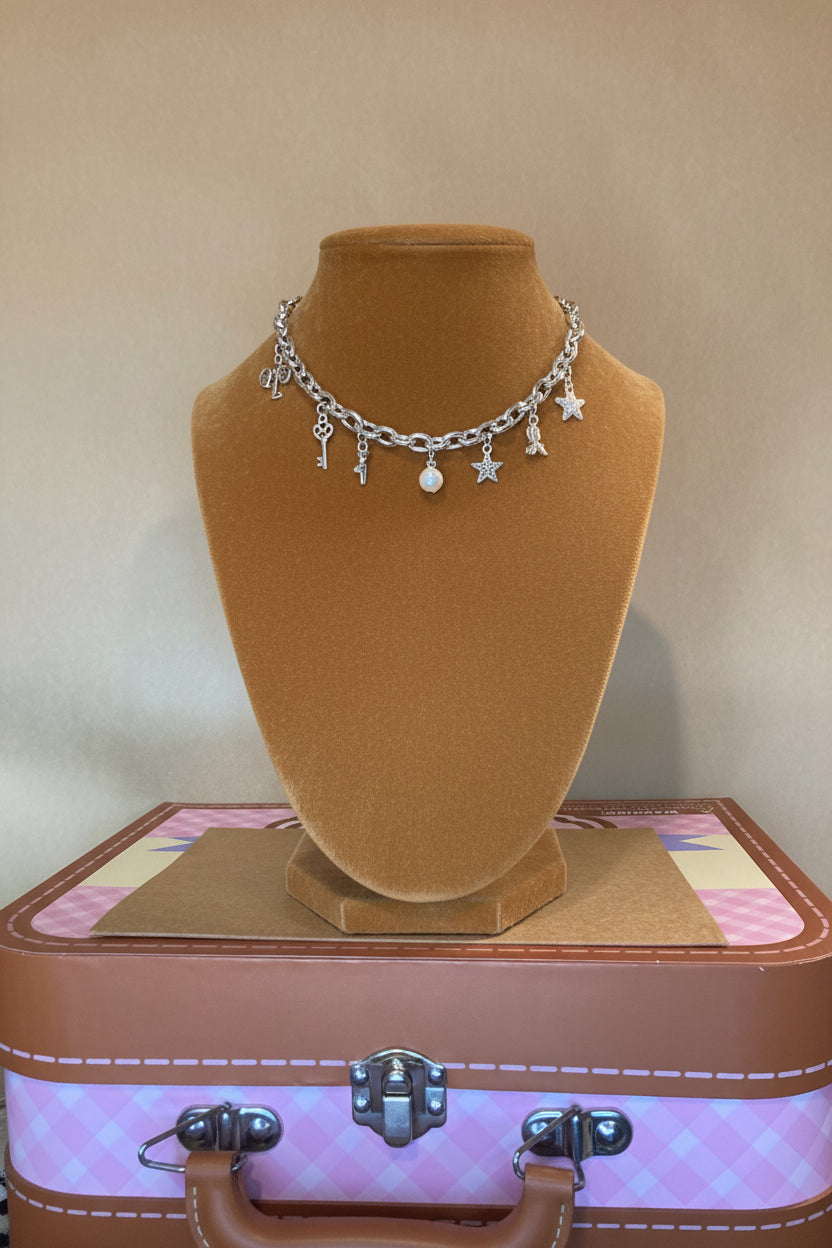 Black jewelry display with Cuban link bracelet on a Carmel surface displaying how charms might look 