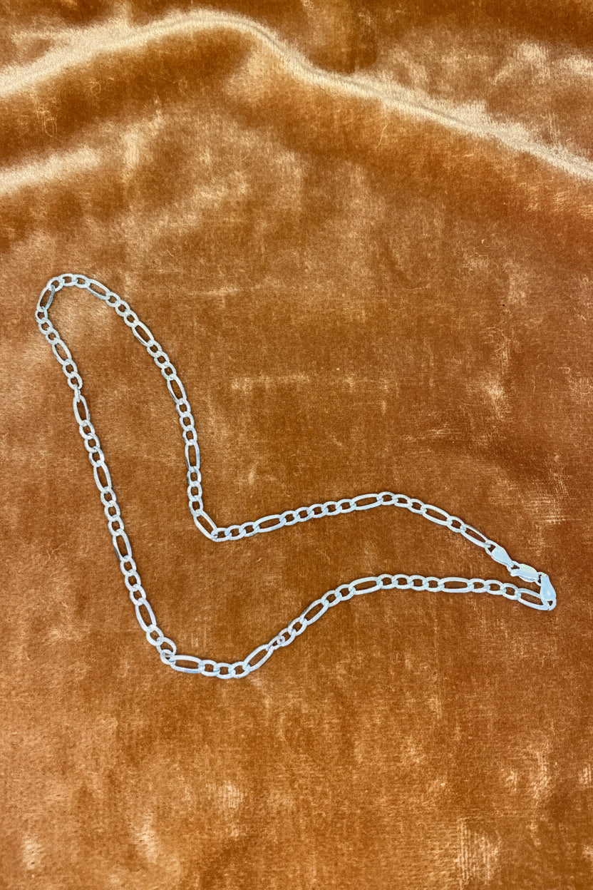 925 Sterling Silver chain on a carmel  fabric background