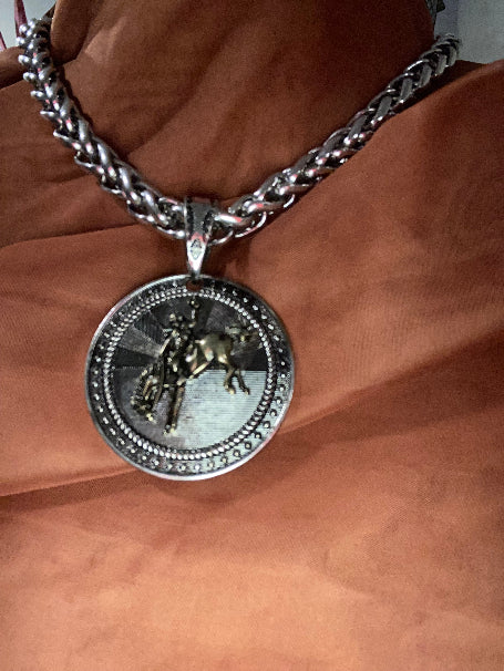 Rolo Link Necklace pendant with Bucking Bronco on brown background.