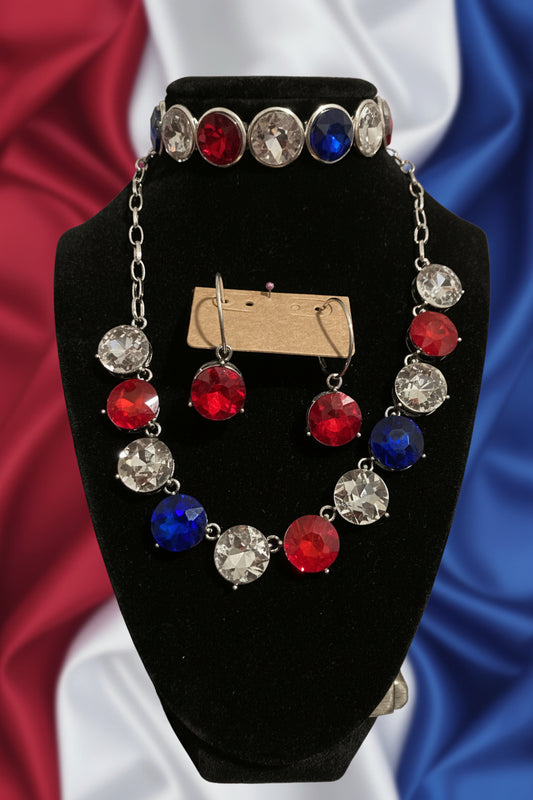 Bracelet with red, blue, and clear gemstones on a black stand against a Rose background