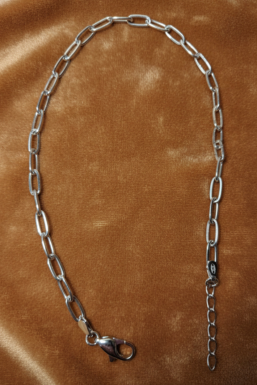 Sterling Silver Anklet a beige background