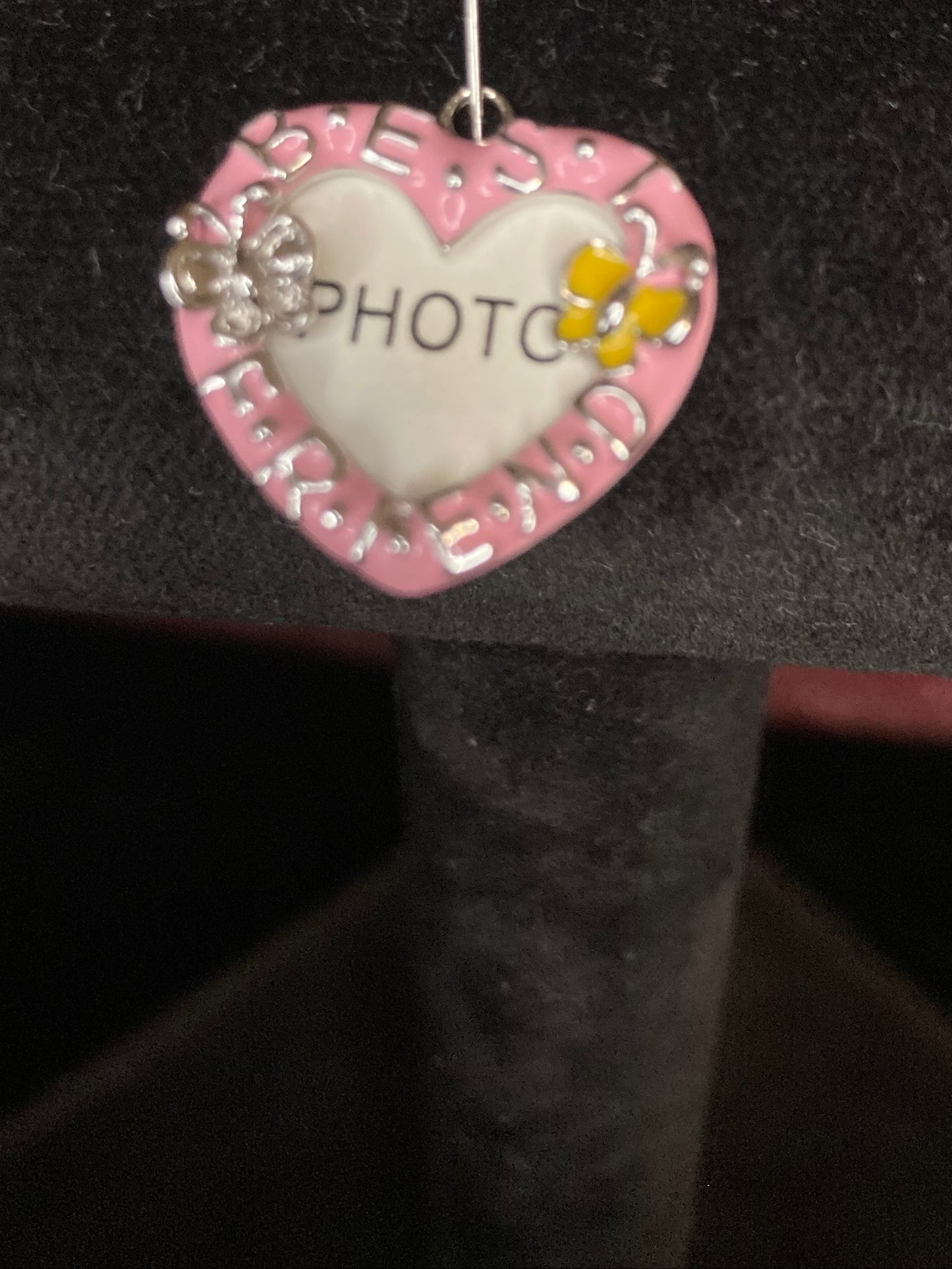 Heart-shaped decorative charm with 'PHOTO' on a black background