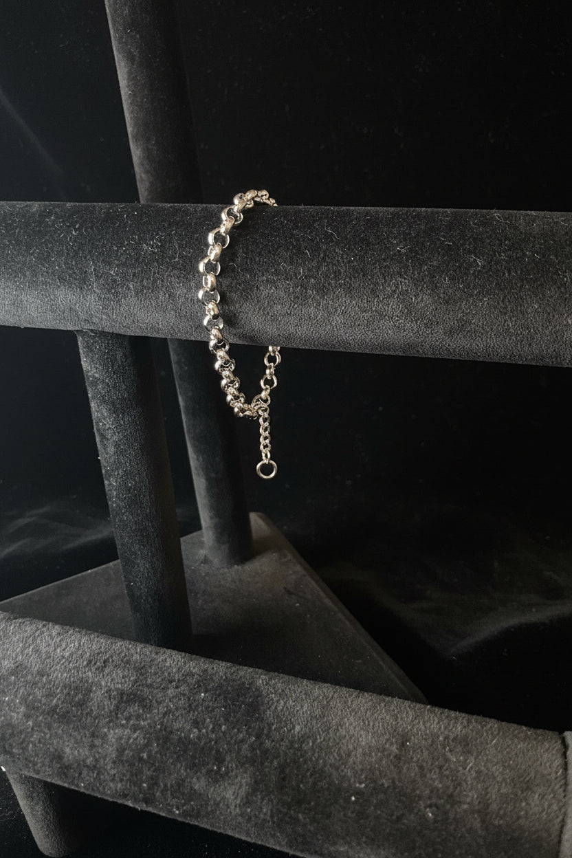 Silver 925 Sterling Silver bracelet on a black stand with Black background