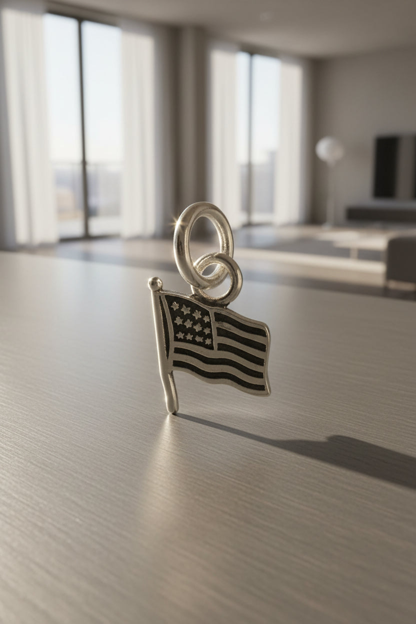 Silver American flag charm on a black background