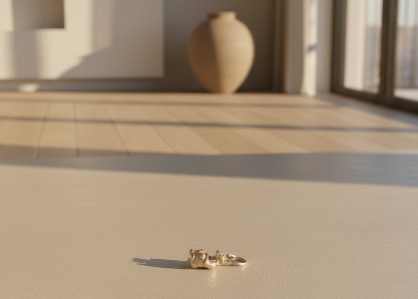 Small Silver Monkey charm on a Beige Background