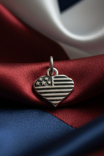 Silver heart-shaped charm with flag design 