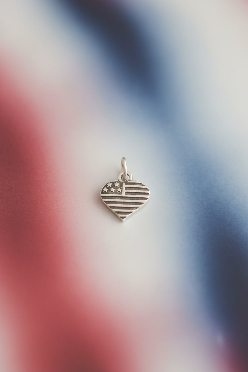 Silver heart-shaped charm with warm background