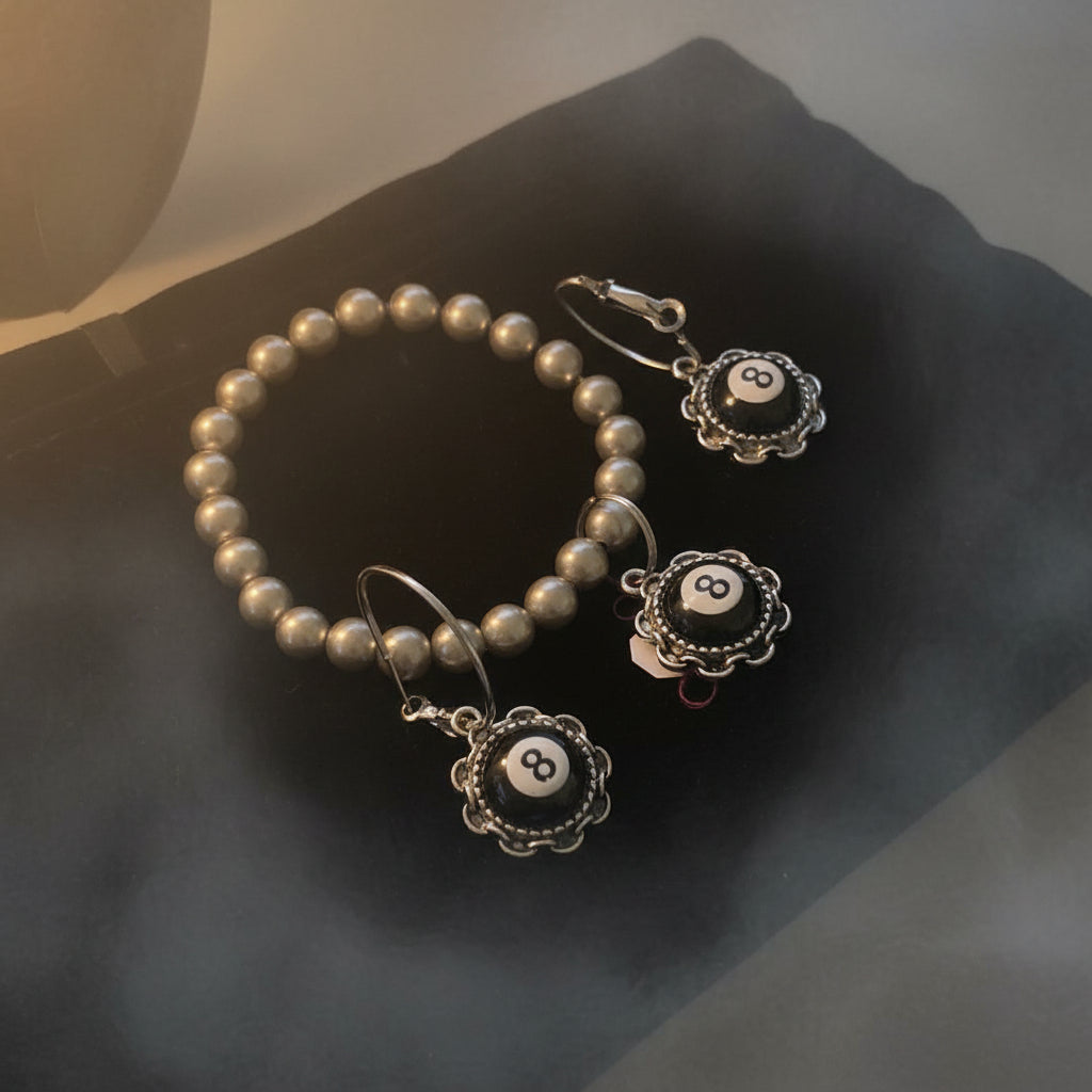 Bead Bracelet and matching earrings on a grey surface