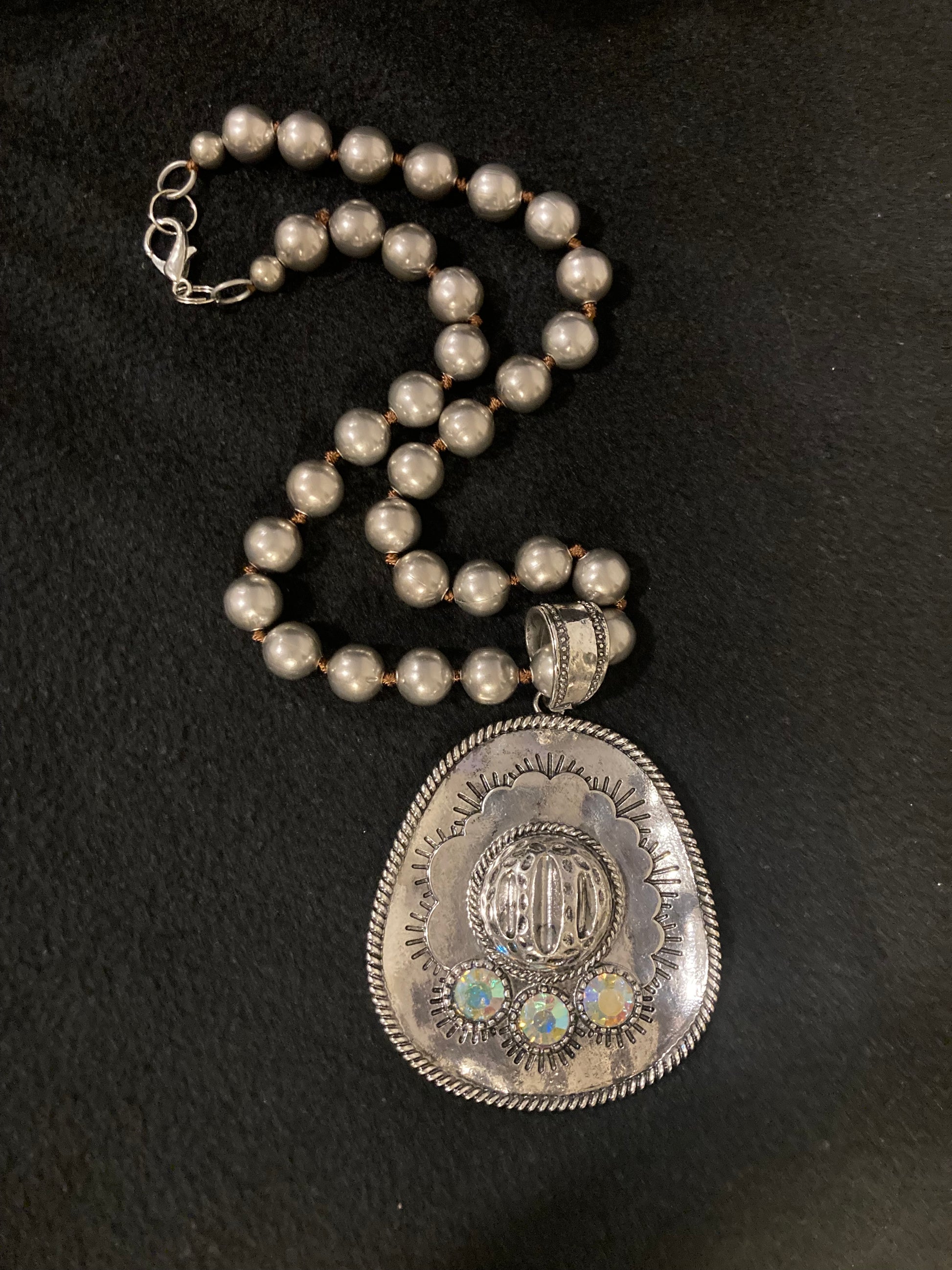 Silver Plated beaded Necklace with gems on a black background