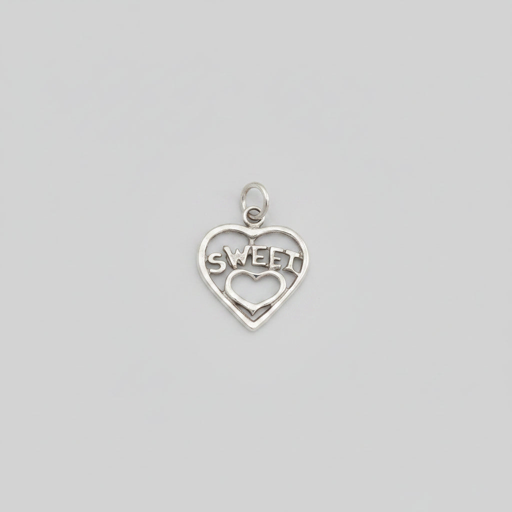 Silver heart-shaped charm with 'SWEET' engraved on a black background