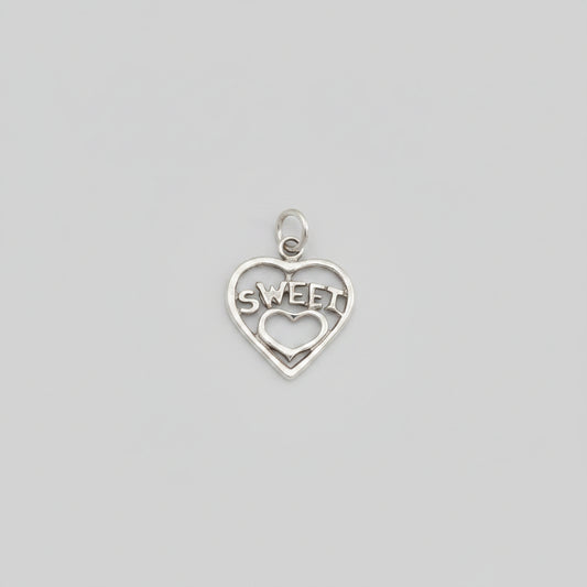 Silver heart-shaped charm with 'SWEET' engraved on a black background