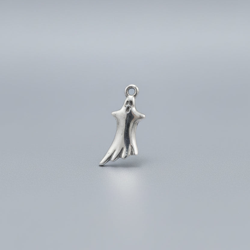 Silver hand-shaped ghost charm on a black background