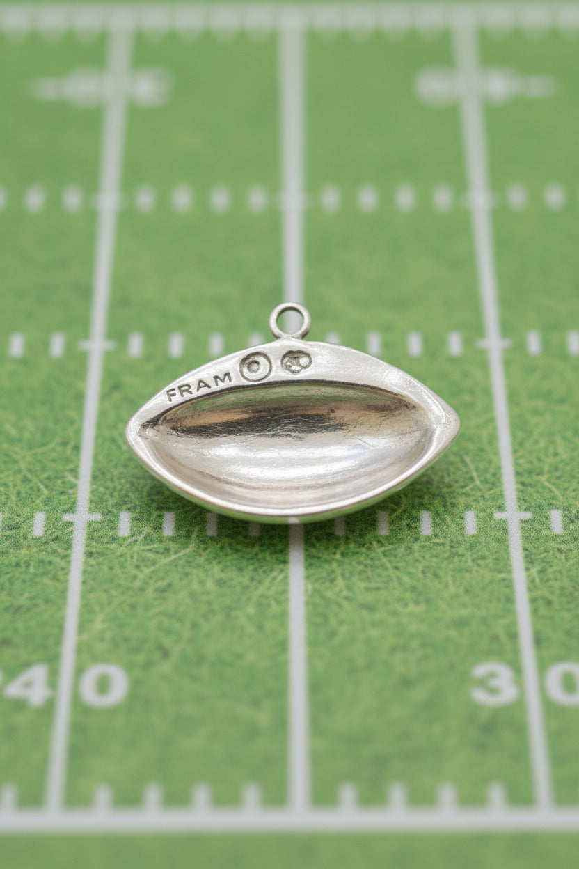 Sterling Silver football replica Charm on a black back view background