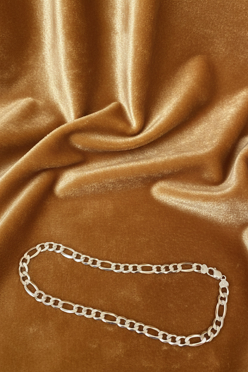 Silver chain necklace on a Carmel velvet background
